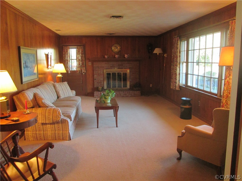 8222 Overbury Road Richmond, VA 23227 - Photo 11 of 16 Wood paneled family room with raised brick FP and
