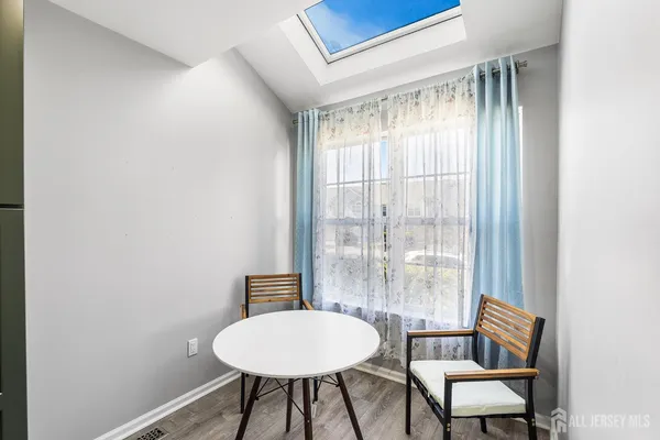 a large bedroom with a bed and a chandelier