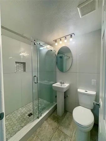 a bathroom with a toilet sink and shower