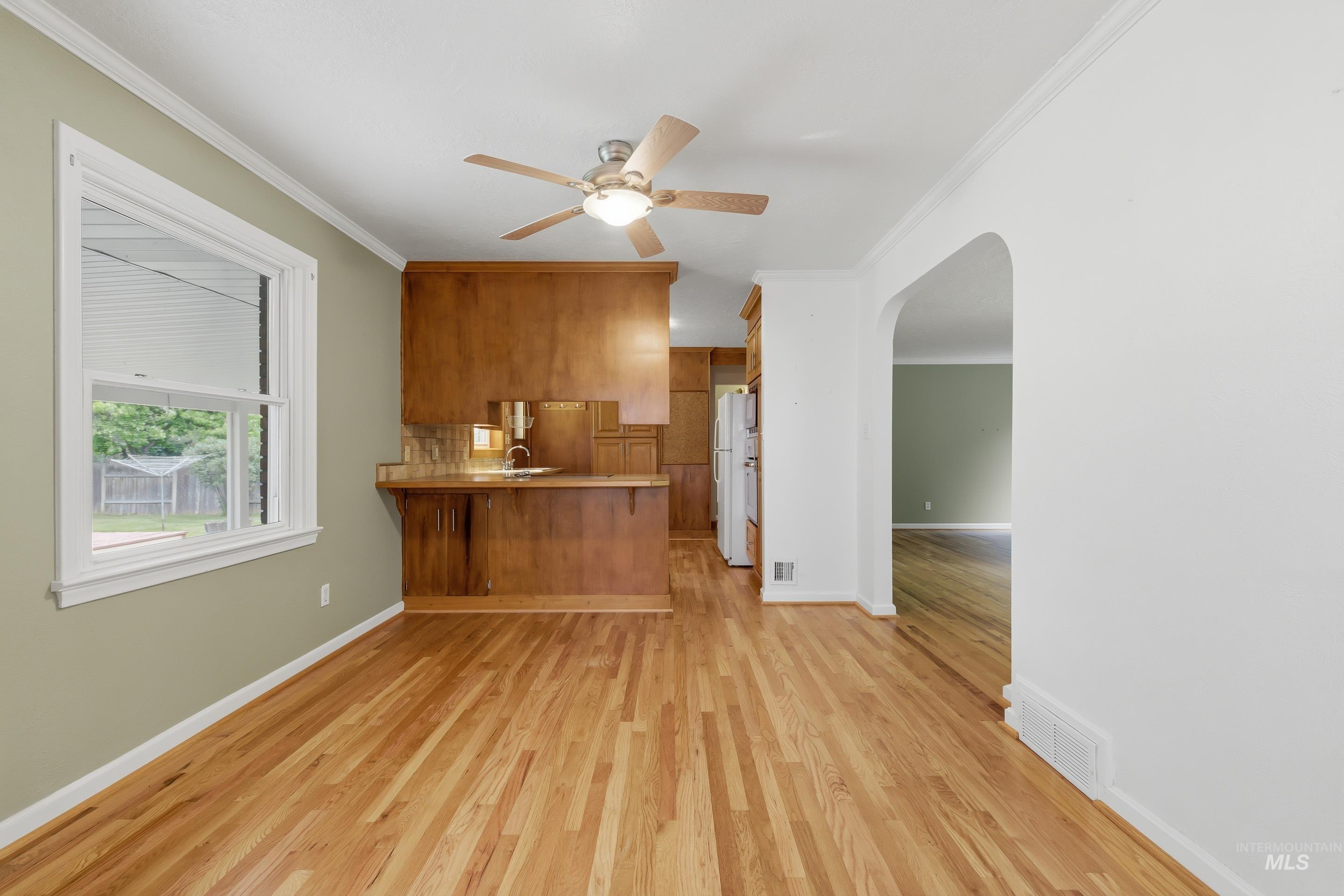 504 West Howe Street Boise, ID 83706 - Photo 14 of 47 Hardwood flooring spanning the room, featuring a built-in wood-finish cabinet with a countertop