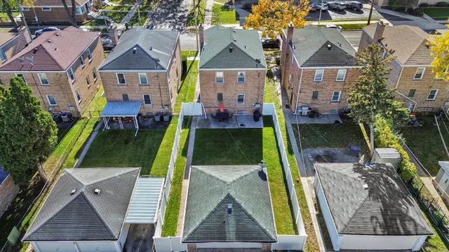 an aerial view of a house with swimming pool garden and patio