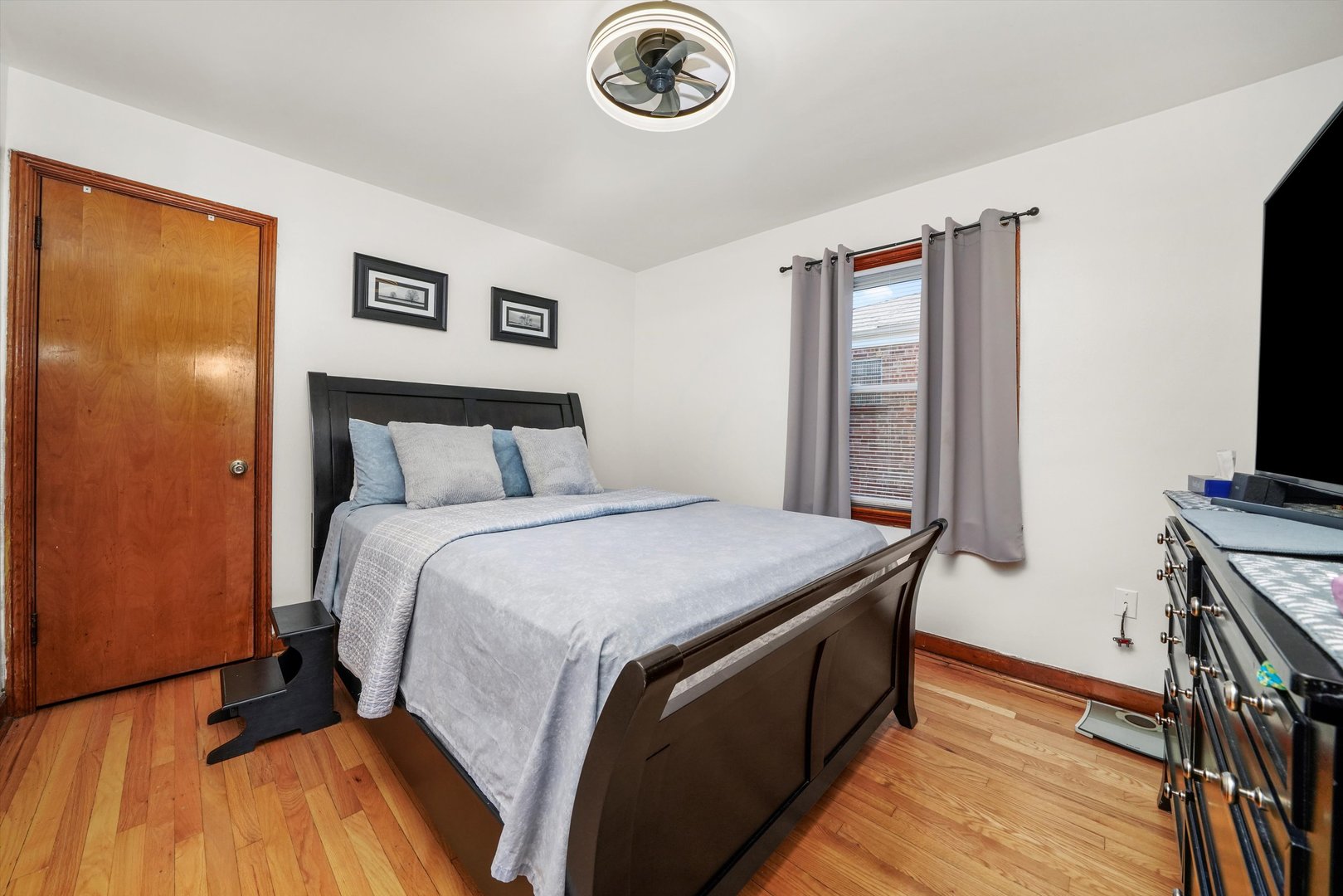 3401 Jackson Street Bellwood, IL 60104 - Photo 8 of 26 a bedroom with a bed and a flat screen tv