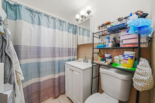 a bathroom with a sink a toilet and shower curtain