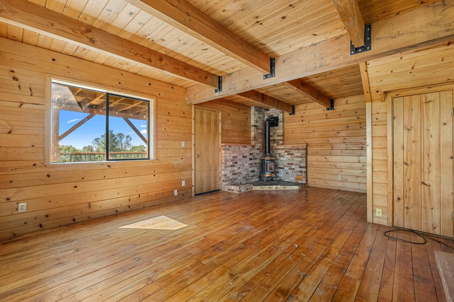 8221 Stoney Creek Road Somerset, CA 95684 - Photo 23 of 44 a view of empty room with wooden floor