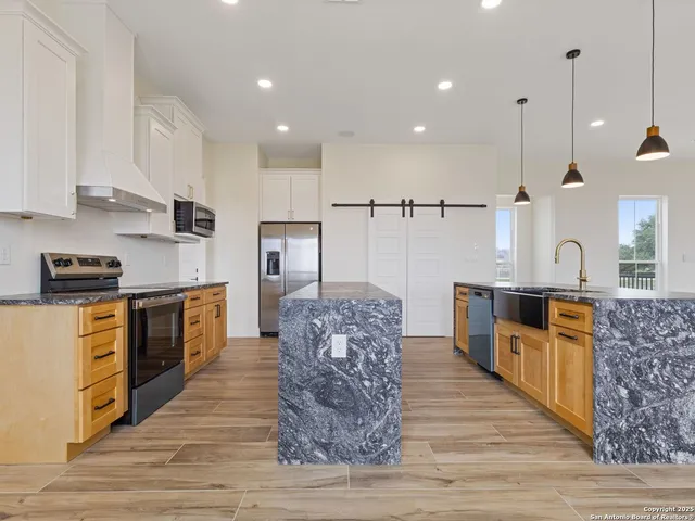 a view of a hallway with stairs and wooden floor
