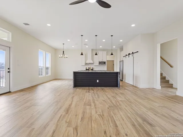 a view of kitchen and hall with wooden floor