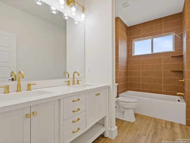 a spacious bathroom with a double vanity sink a mirror and a shower