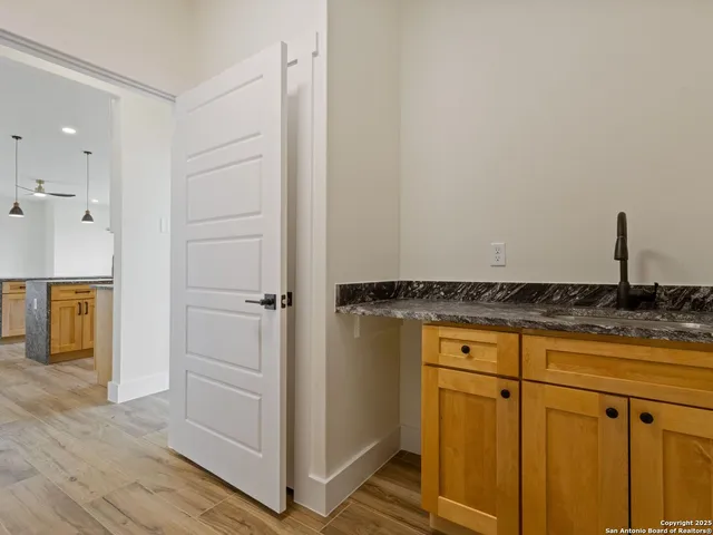 a view of white cabinets and a wooden floor