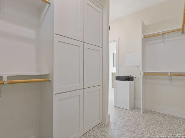 a spacious bathroom with a double vanity sink a mirror and a bathtub