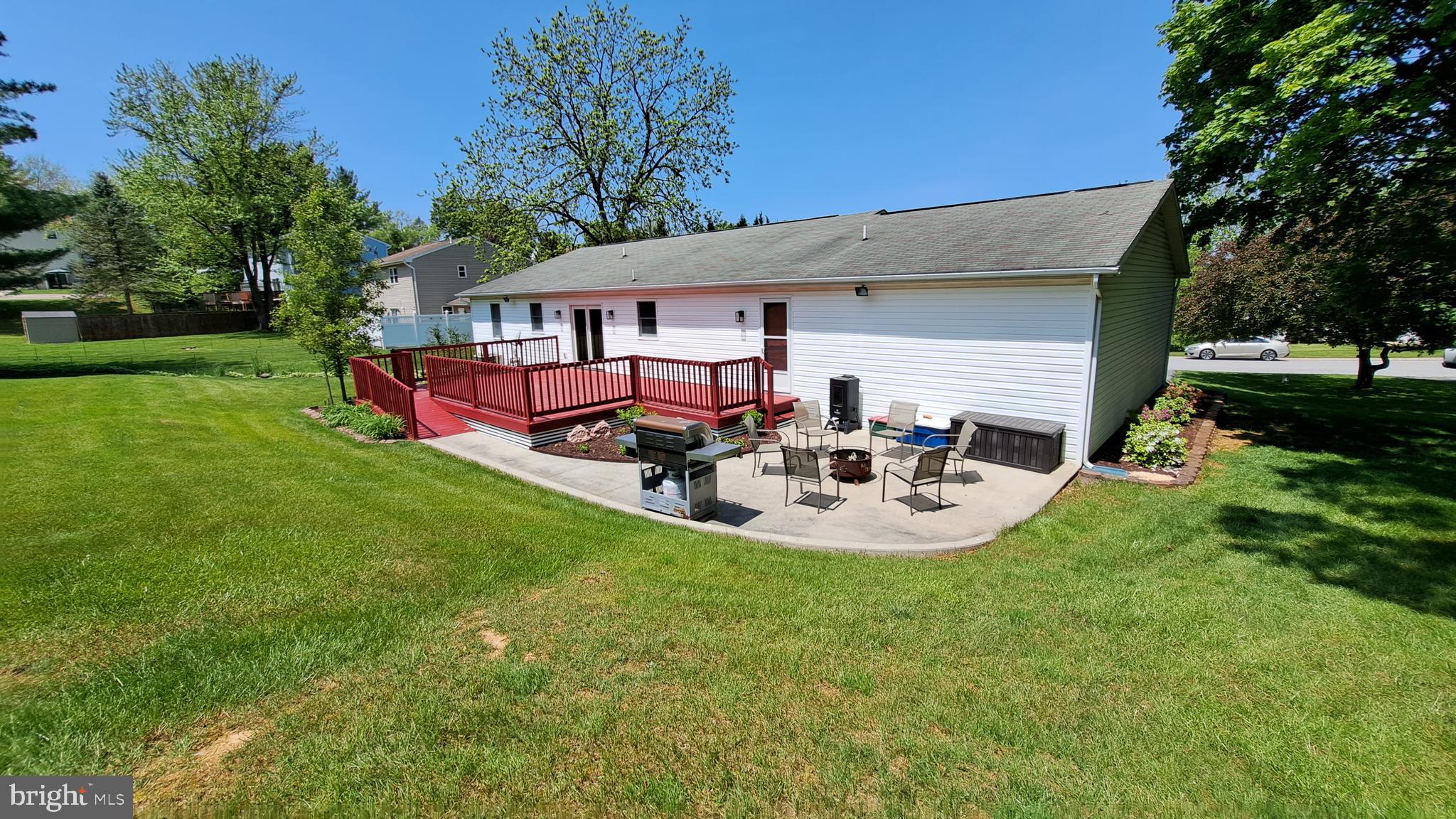212 Ridley Drive York, PA 17402 - Photo 13 of 68 a view of a patio with table and chairs potted plants and large tree
