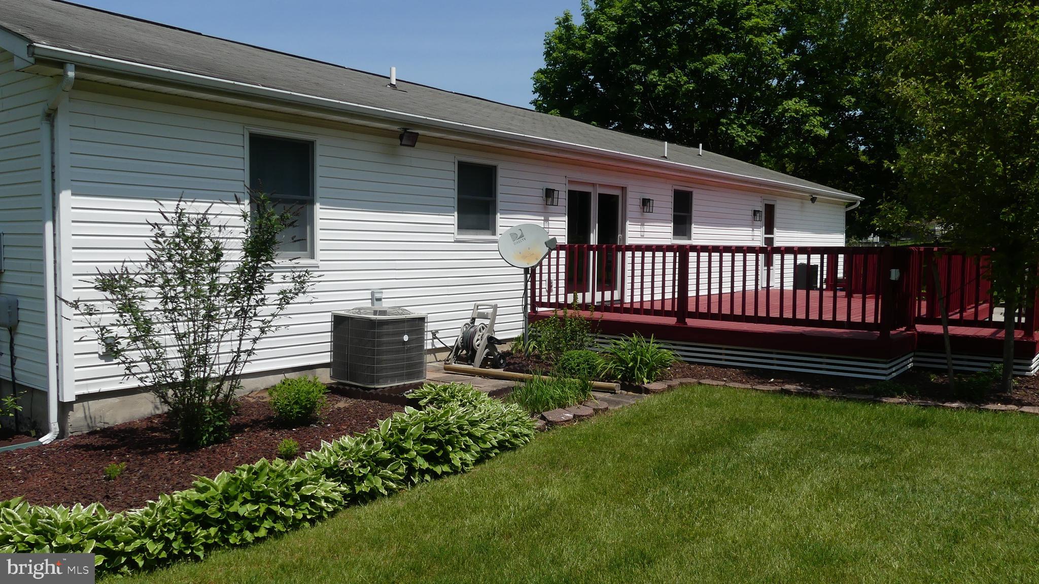 212 Ridley Drive York, PA 17402 - Photo 23 of 68 a view of a house with wooden deck and a yard