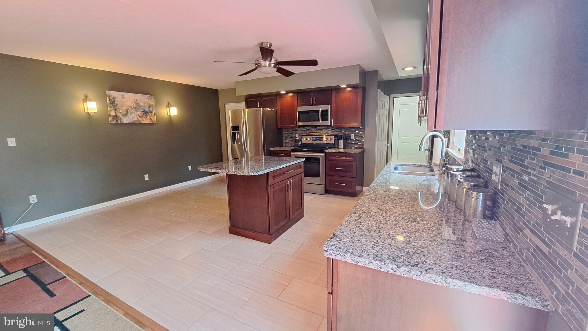 212 Ridley Drive York, PA 17402 - Photo 33 of 68 a kitchen with granite countertop a sink a stove and cabinets