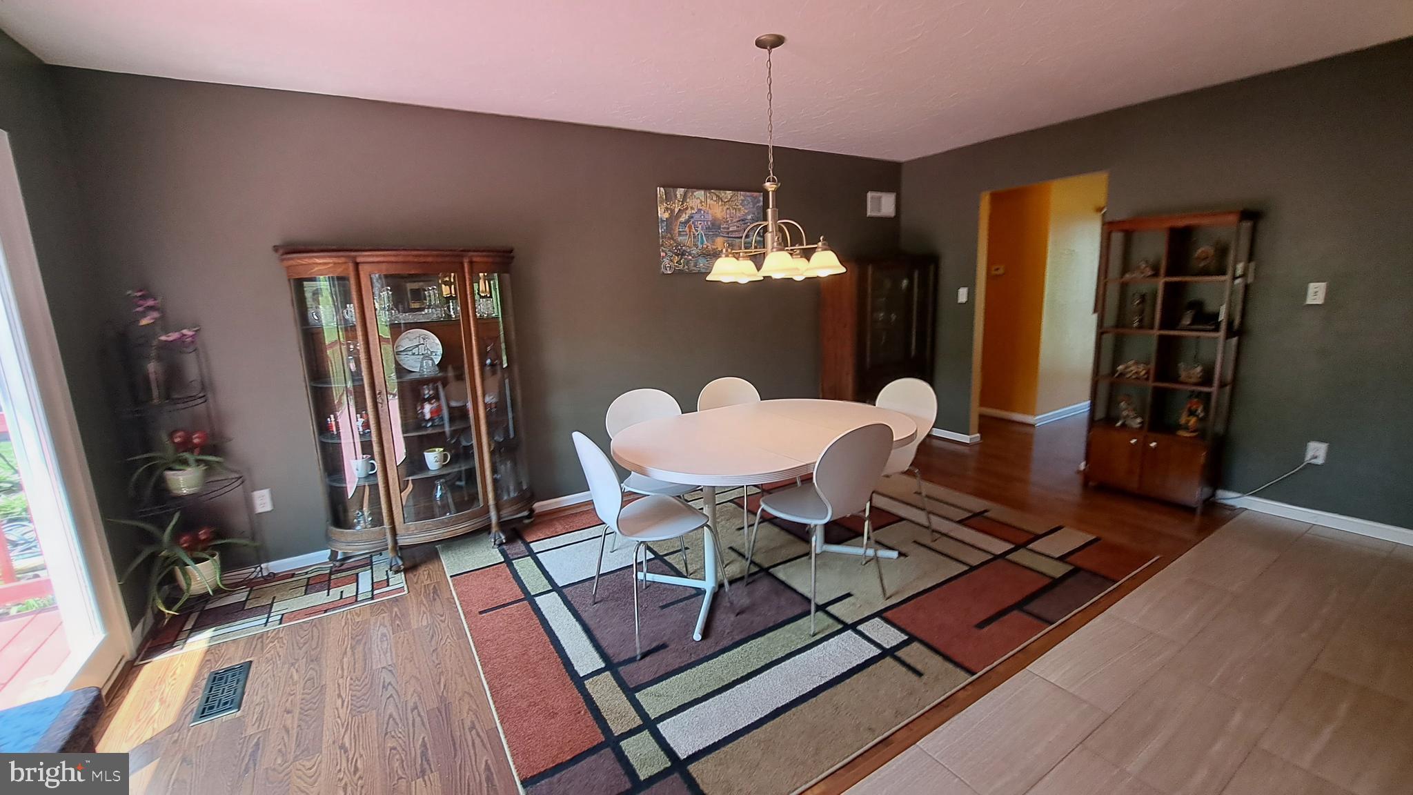 212 Ridley Drive York, PA 17402 - Photo 39 of 68 a dining room with furniture a chandelier and wooden floor