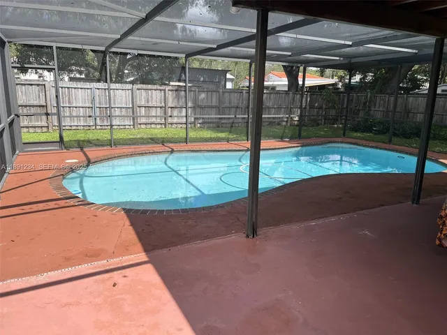an aerial view of a house with a swimming pool