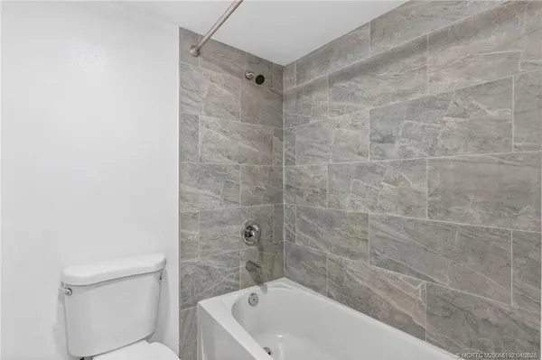 a bathroom with a bathtub and a toilet
