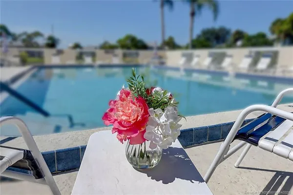 a view of a swimming pool with lounge chairs