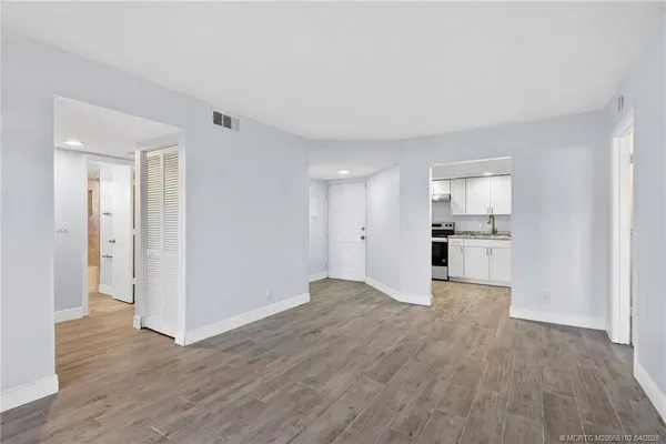 a view of a kitchen with wooden floor