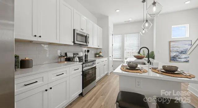 a kitchen with cabinets a sink and appliances