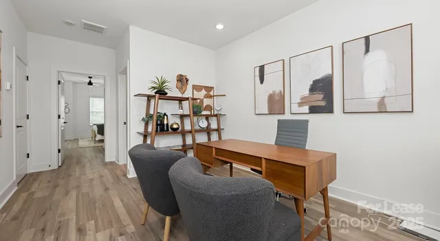 a view of a livingroom with furniture and wooden floor