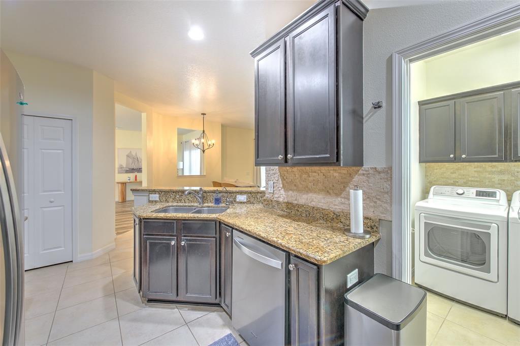 5409 Conch Shell Place Apollo Beach, FL 33572 - Photo 13 of 51 a kitchen with a sink stove and refrigerator