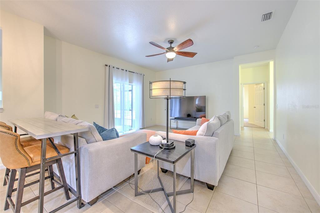 5409 Conch Shell Place Apollo Beach, FL 33572 - Photo 16 of 51 a living room with furniture a flat screen tv and a table