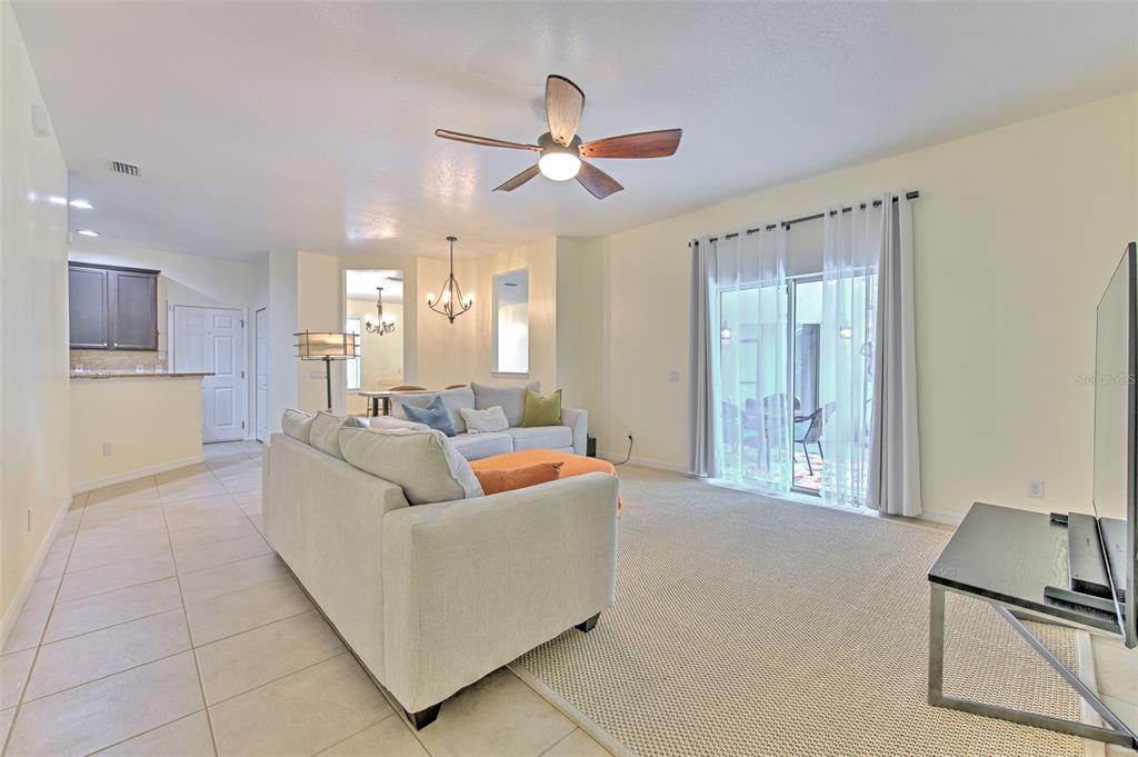 5409 Conch Shell Place Apollo Beach, FL 33572 - Photo 18 of 51 a living room with furniture and a ceiling fan
