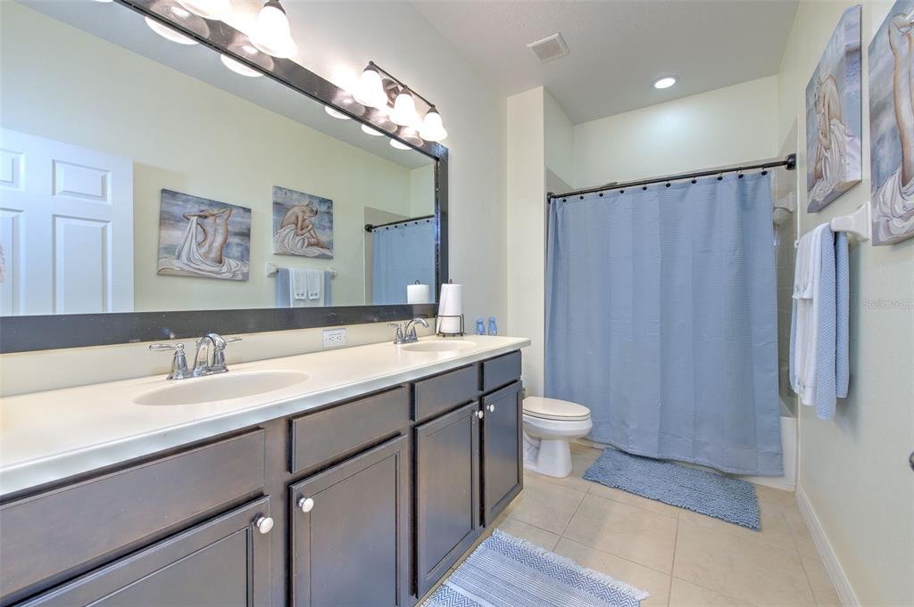 5409 Conch Shell Place Apollo Beach, FL 33572 - Photo 21 of 51 a bathroom with a double vanity sink toilet and shower