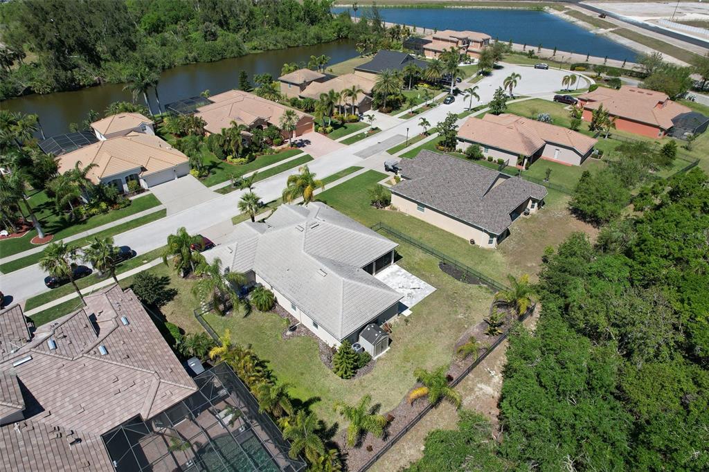 5409 Conch Shell Place Apollo Beach, FL 33572 - Photo 3 of 51 an aerial view of a house with a garden and lake view