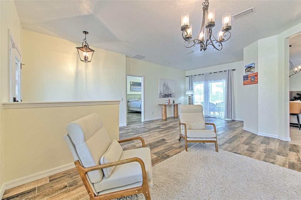 5409 Conch Shell Place Apollo Beach, FL 33572 - Photo 8 of 51 a living room with furniture and a chandelier