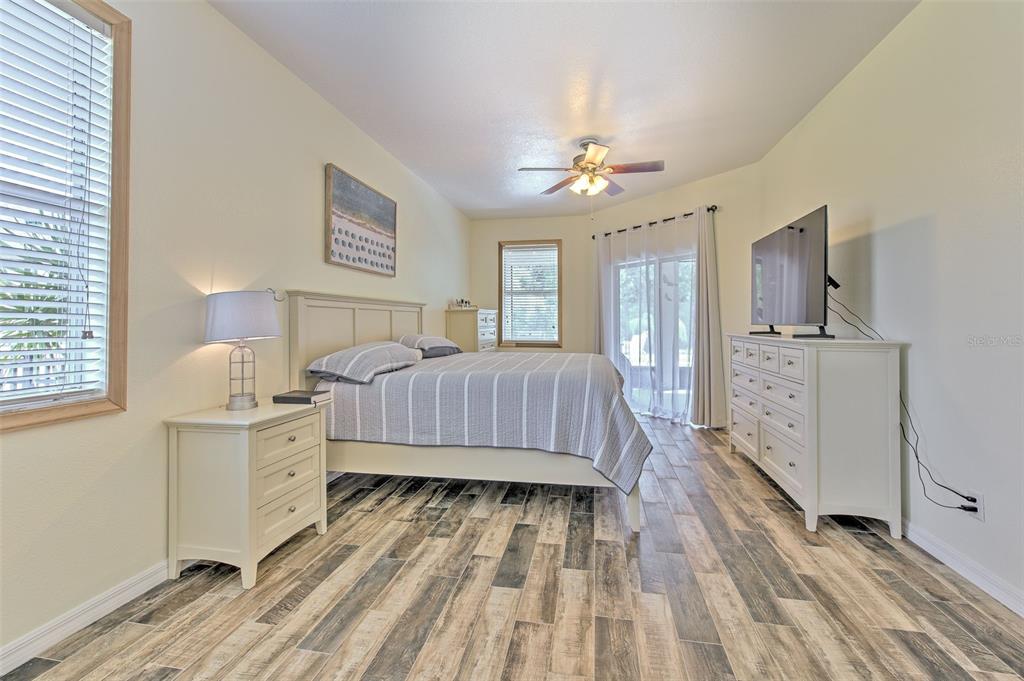 5409 Conch Shell Place Apollo Beach, FL 33572 - Photo 10 of 51 a spacious bedroom with a bed dresser and a window