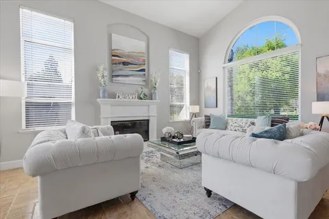 a living room with furniture and a large window