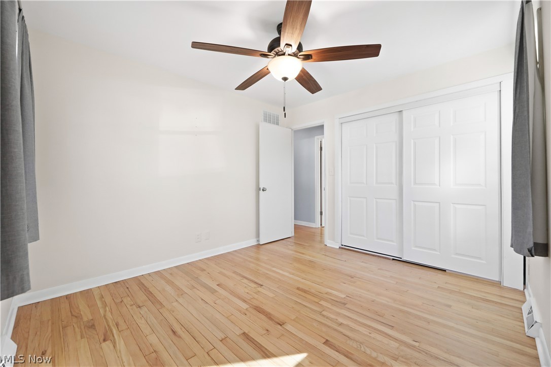 4003 Kenneth Road Stow, OH 44224 - Photo 29 of 50 Unfurnished bedroom with light wood-type flooring, a ceiling fan, and a closet