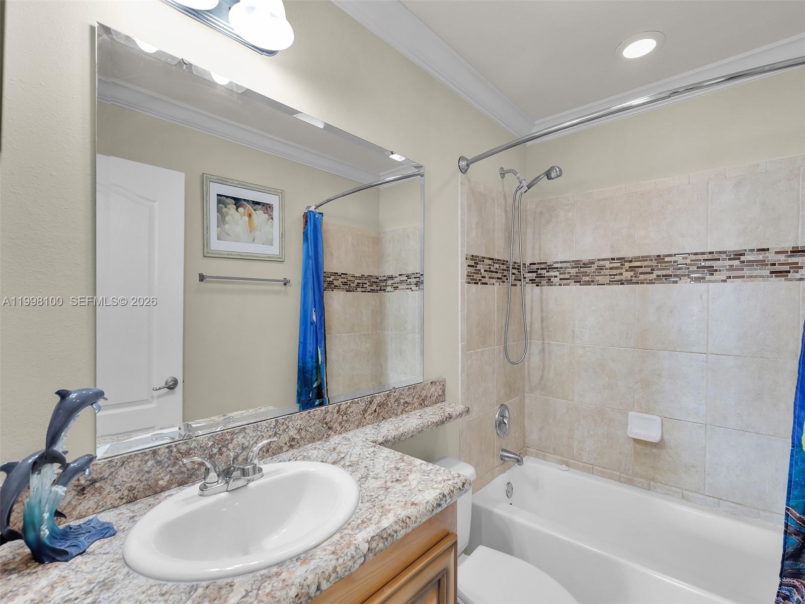 437 Pirates Road Summerland Key, FL 33042 - Photo 31 of 39 a bathroom with a granite countertop sink a mirror a shower and a bathtub