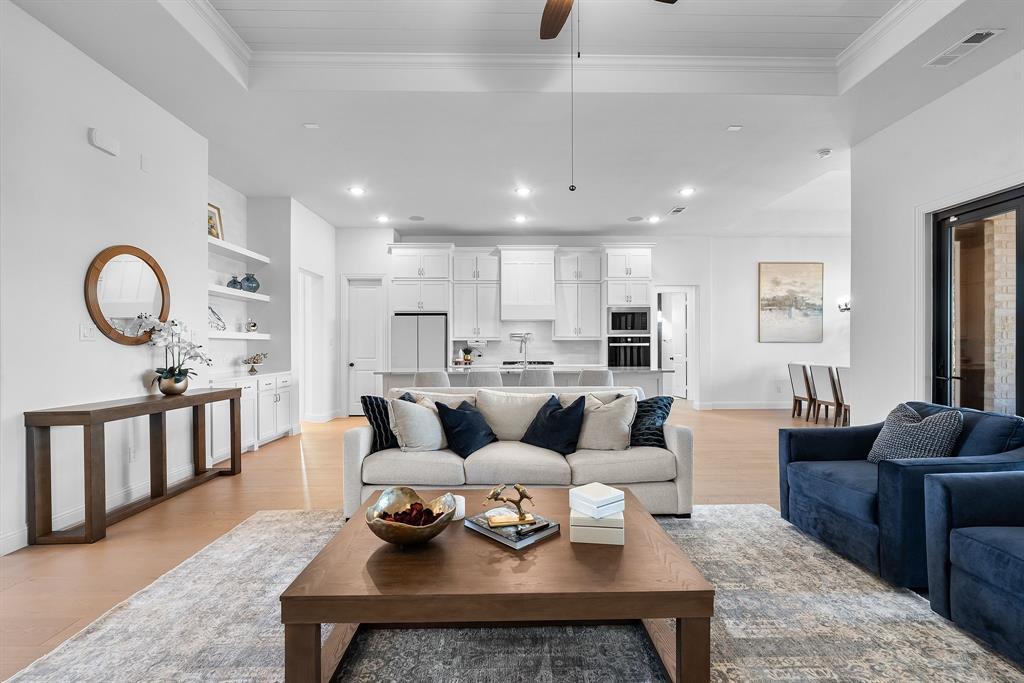 2248 Meander Way Northlake, TX 76247 - Photo 12 of 40 a living room with furniture kitchen view and a wooden floor