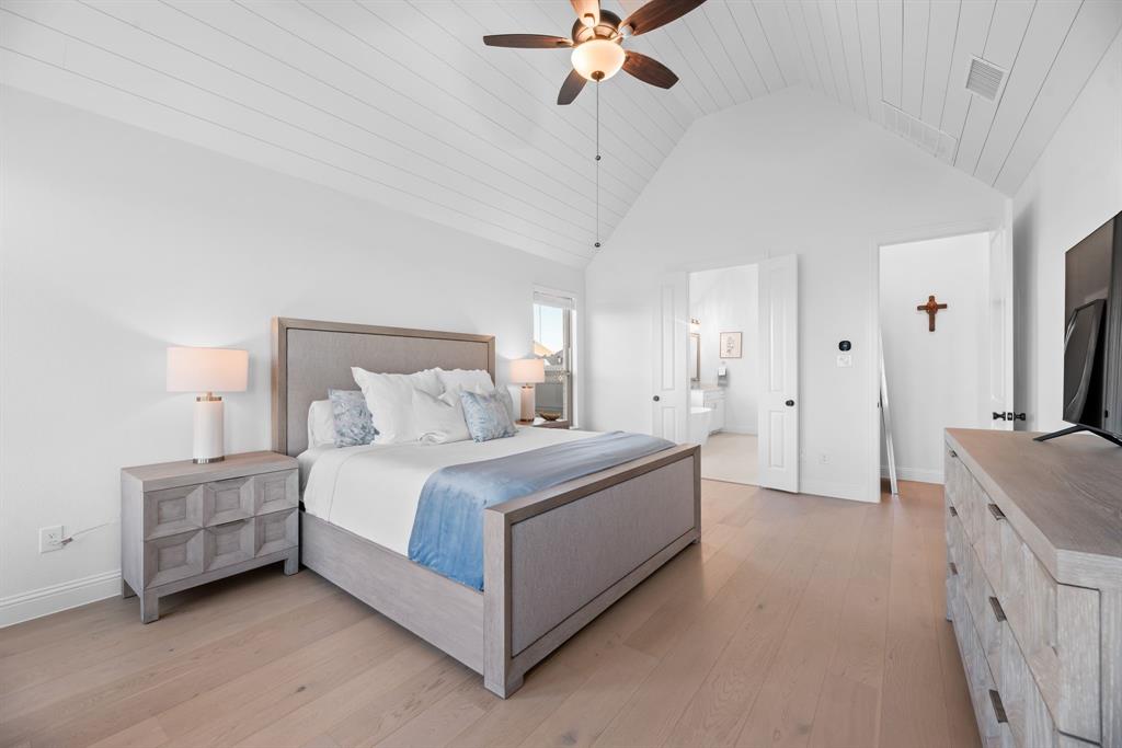 2248 Meander Way Northlake, TX 76247 - Photo 17 of 40 a spacious bedroom with a bed and a chandelier