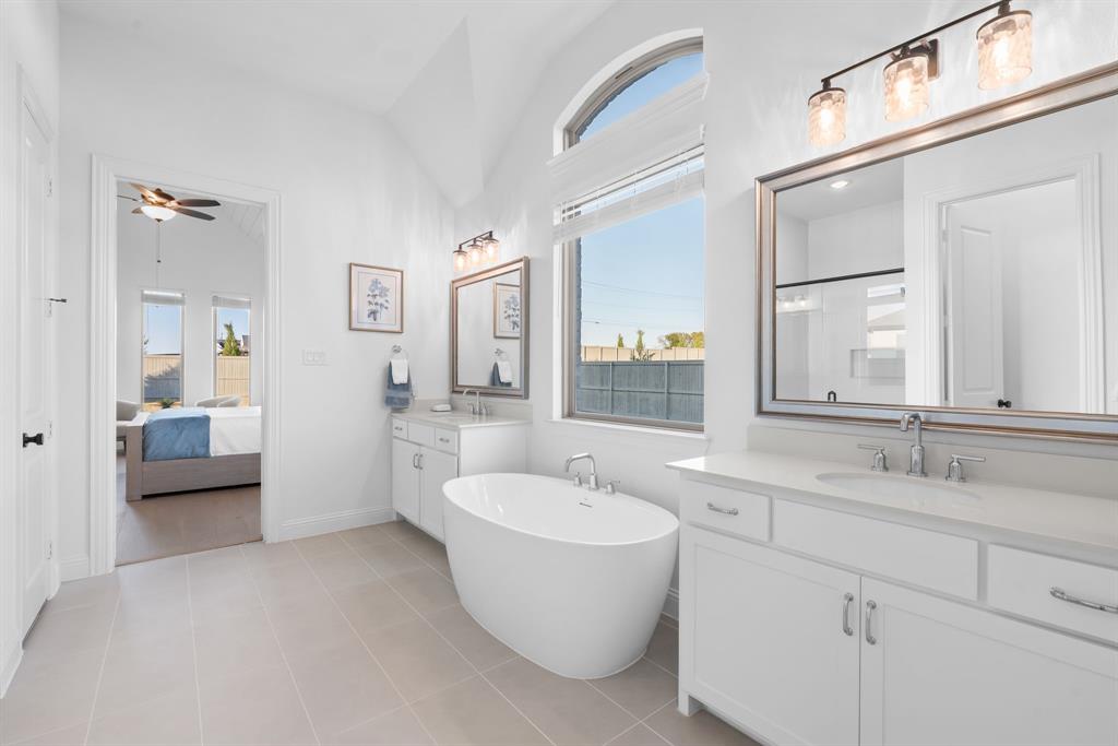 2248 Meander Way Northlake, TX 76247 - Photo 19 of 40 a bathroom with a double vanity sink a mirror and a bathtub