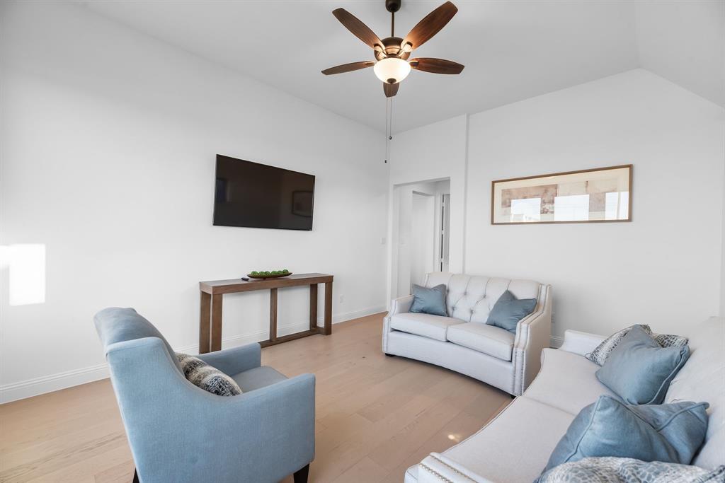 2248 Meander Way Northlake, TX 76247 - Photo 23 of 40 a living room with furniture and a flat screen tv