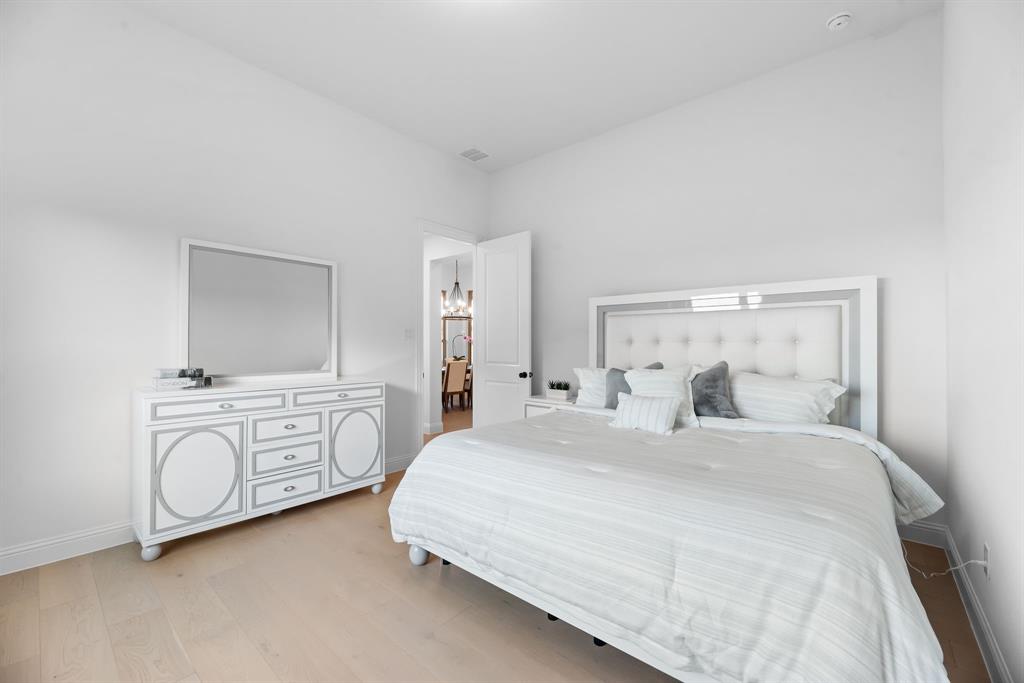 2248 Meander Way Northlake, TX 76247 - Photo 25 of 40 a bedroom with a bed dresser and wooden floor