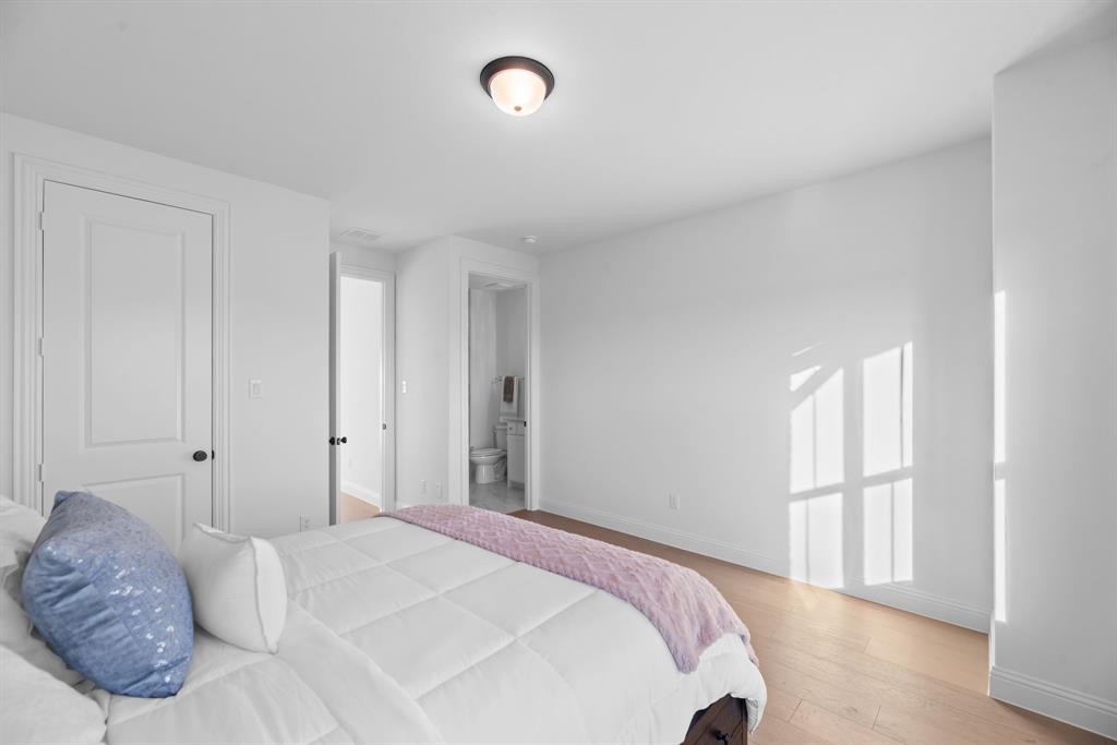 2248 Meander Way Northlake, TX 76247 - Photo 30 of 40 a bedroom with a bed and a painting on the wall