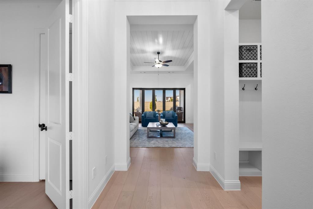 2248 Meander Way Northlake, TX 76247 - Photo 5 of 40 a view of a hallway with furniture and a livingroom
