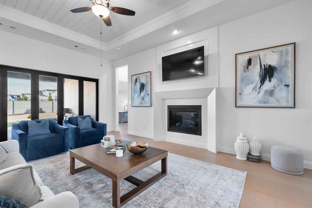 2248 Meander Way Northlake, TX 76247 - Photo 8 of 40 a living room with furniture a flat screen tv and a fireplace