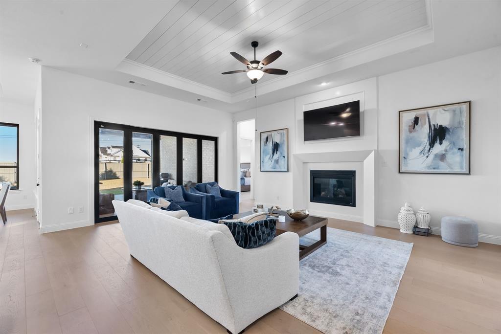 2248 Meander Way Northlake, TX 76247 - Photo 9 of 40 a living room with furniture a fireplace and a ceiling fan