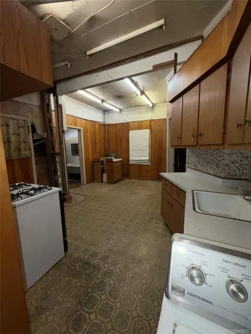 a kitchen with stainless steel appliances granite countertop a stove a refrigerator and a refrigerator