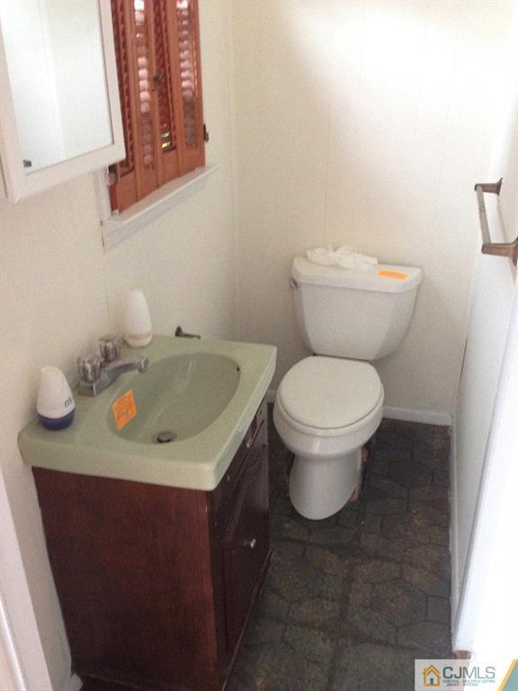 17 Moryan Road Edison, NJ 08817 - Photo 11 of 13 a bathroom with a toilet sink and mirror