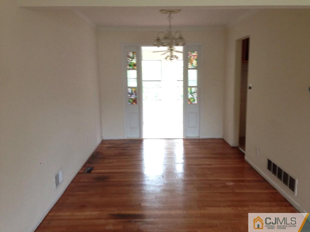 17 Moryan Road Edison, NJ 08817 - Photo 12 of 13 a view of a hallway with wooden floor and staircase