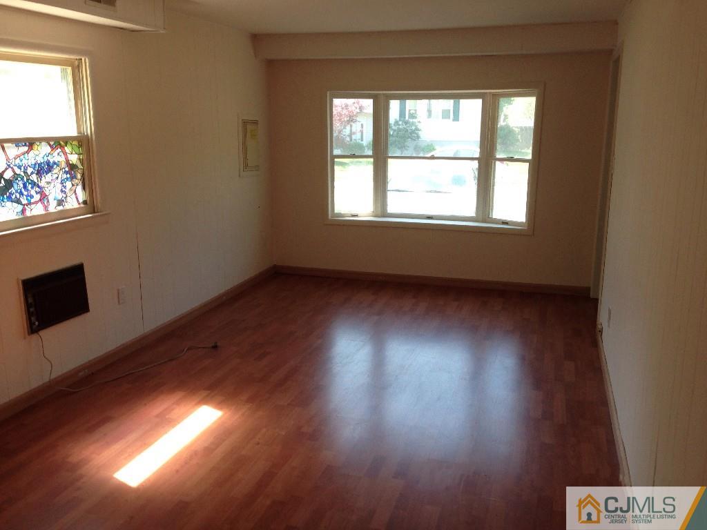 17 Moryan Road Edison, NJ 08817 - Photo 7 of 13 a view of an empty room with wooden floor and a window