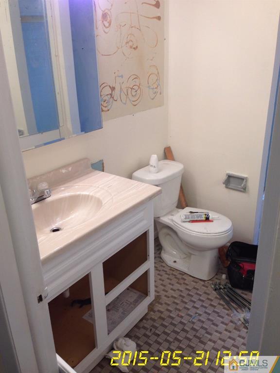 17 Moryan Road Edison, NJ 08817 - Photo 8 of 13 a bathroom with a sink a toilet and a mirror