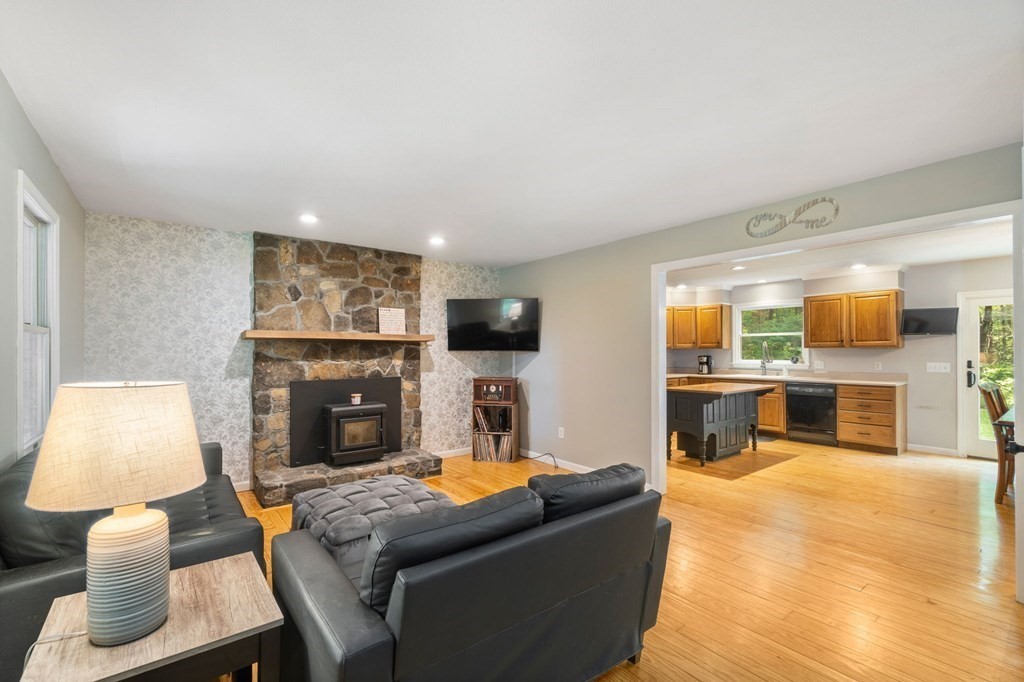 147 Wales Road Monson, MA 01057 - Photo 24 of 41 a living room with furniture a flat screen tv and a fireplace