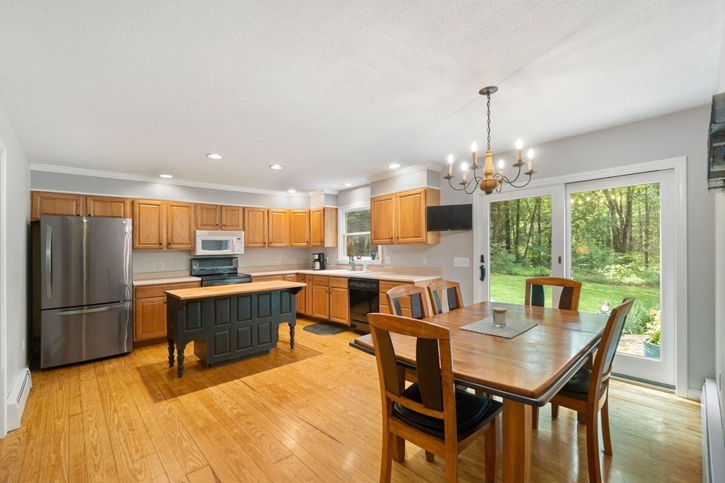 147 Wales Road Monson, MA 01057 - Photo 26 of 41 a dining room with furniture a chandelier and wooden floor