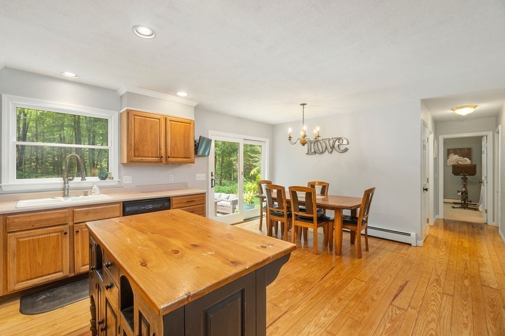 147 Wales Road Monson, MA 01057 - Photo 28 of 41 a dining hall with stainless steel appliances granite countertop a dining table and chairs with wooden floor